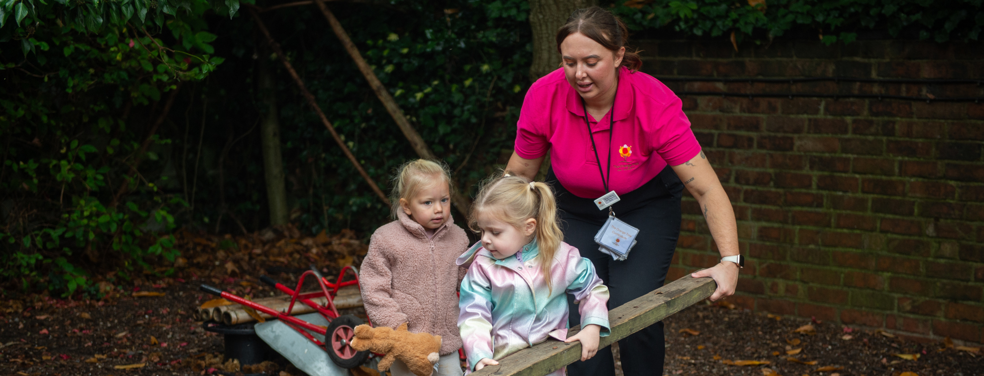 Children exploring and learning outdoors at The Orange Tree Day Nursery